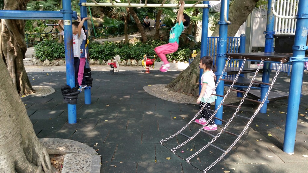 Children playing in the park inside Luis de Camoes Garden