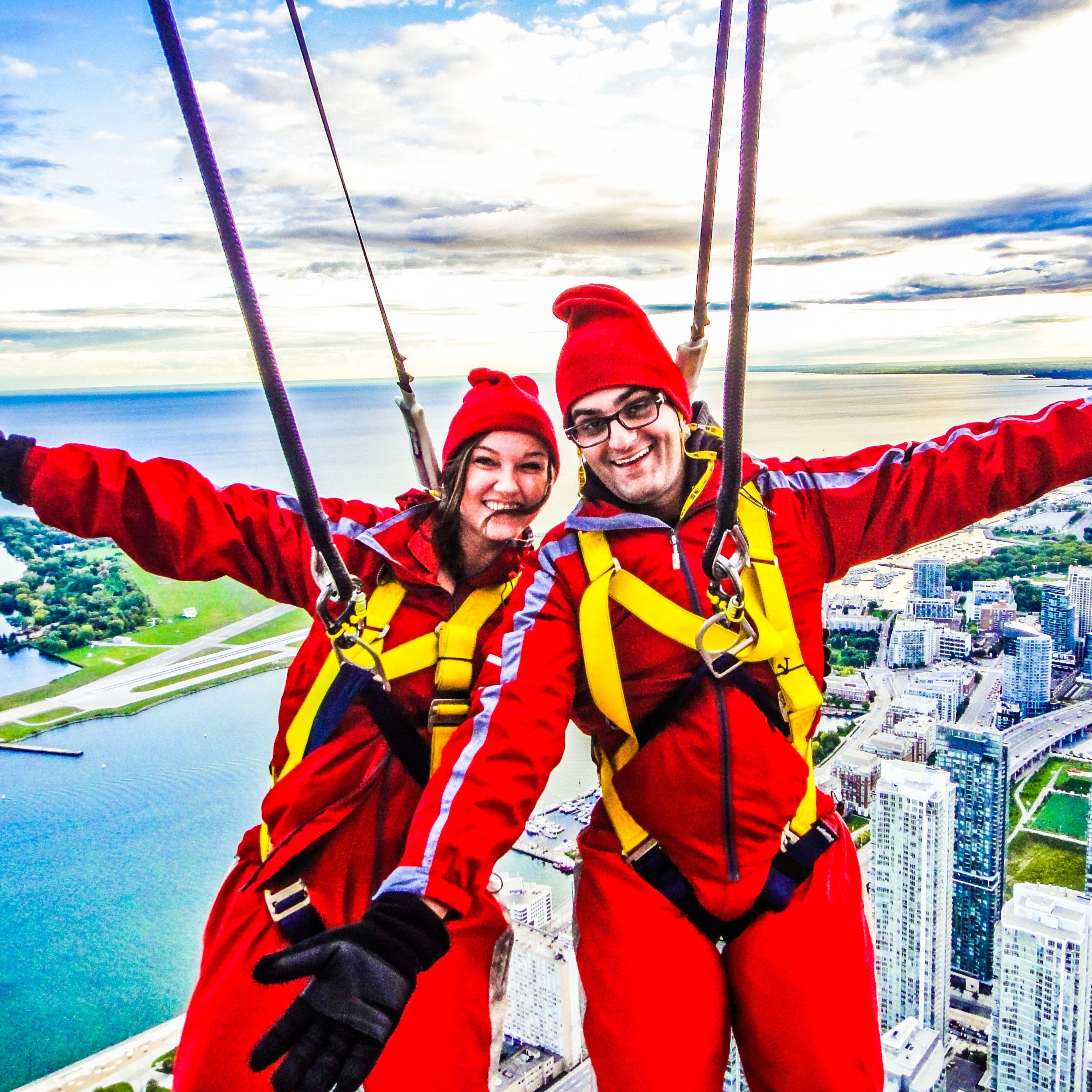 Vacation Couple hang off CN Tower in Toronto, Canada