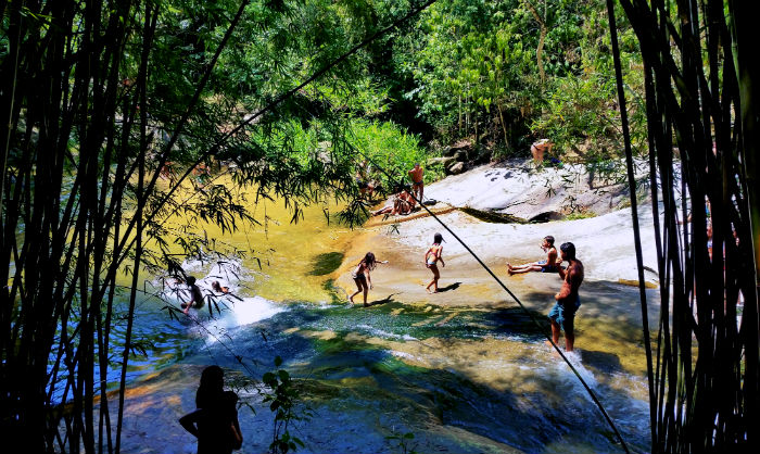 Children playing in a waterfall in Sana, Brazil