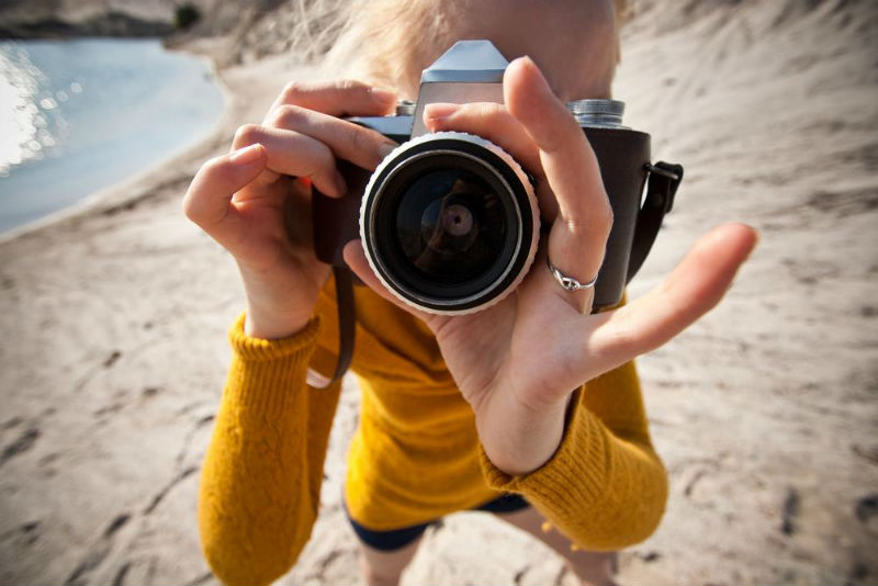 Photo: Tourist with Camera | What to Consider Before Booking an All-Inclusive Resort | StoryV Travel & Lifestyle