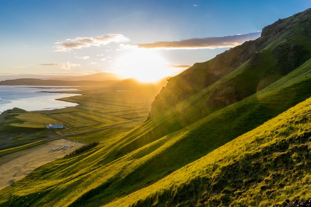 The sun setting between the two glaciers Eyjafjallajokull and Mydralsjokull. Taken from the cliffs right above Reynisfjara beach near Vik-Insider’s Guide: Budget Iceland travel tips