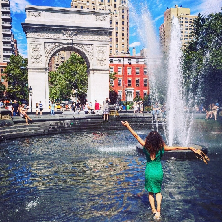 Cooling down in the fountain in Washington Square park while listening to intimate street jazz orchestra - New York travel tips