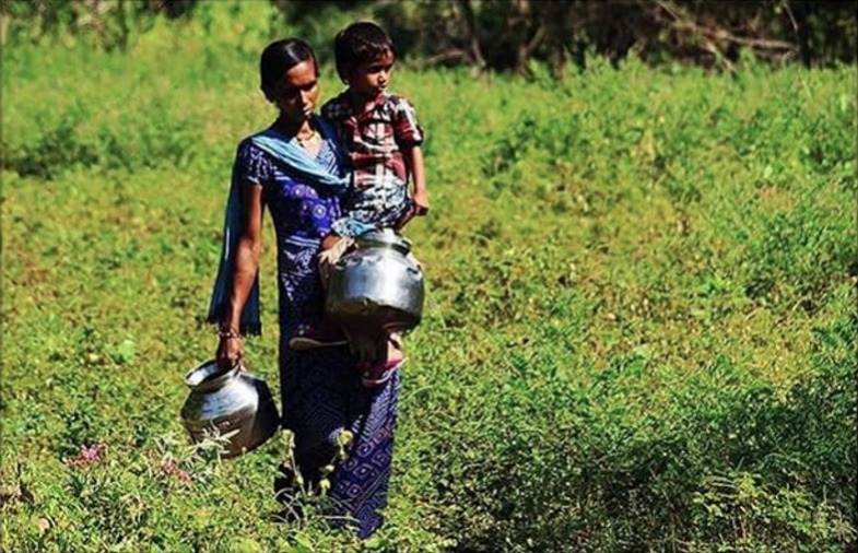 A mother and child walking through the Indian countryside | Essential India Travel Tips You Need To Know Before Visiting