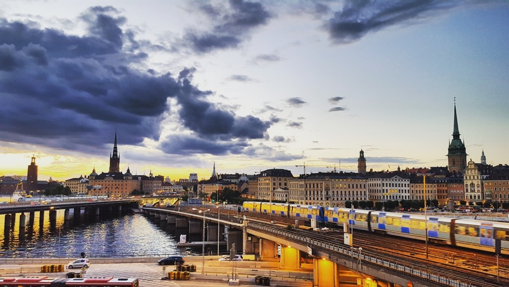 A beautiful Scandinavian summer sunset over Stockholm’s Gamla Stan (Old Town) seen from Ekens Uteservering - Stockholm Travel Guide