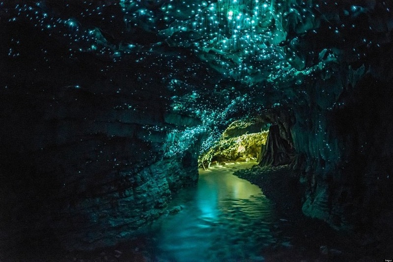 Weird places in the world - narrow passage in the cave lighted up by glowworms
