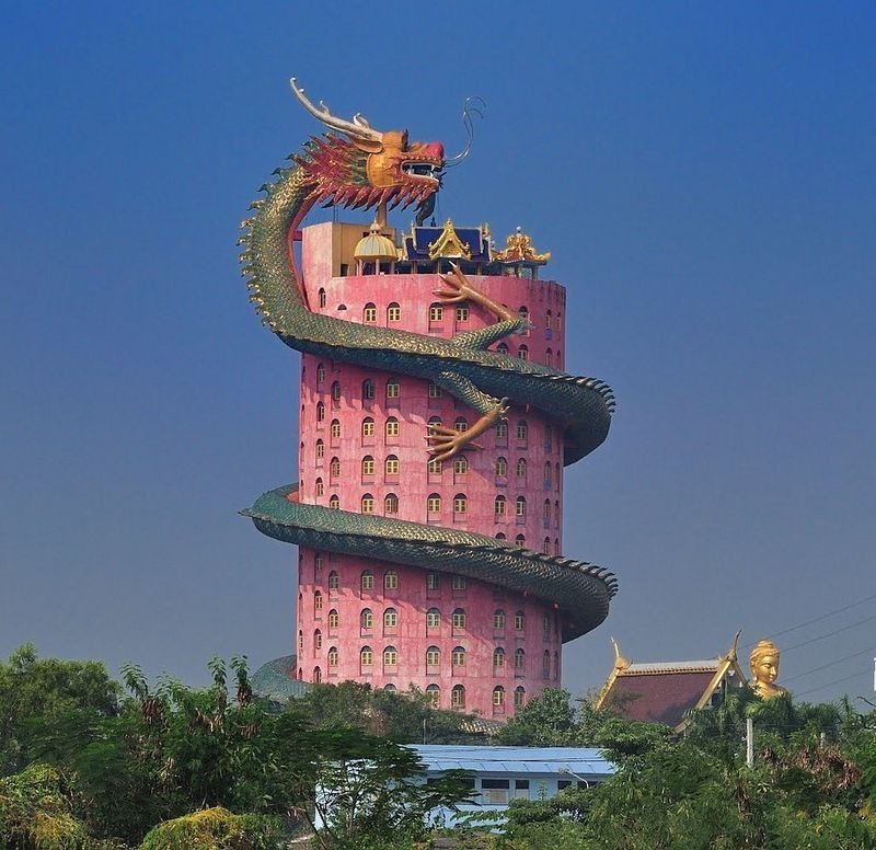 Shades of the World: A dragon sculpture wrapped around Wat Sampran's cylindrical, red building