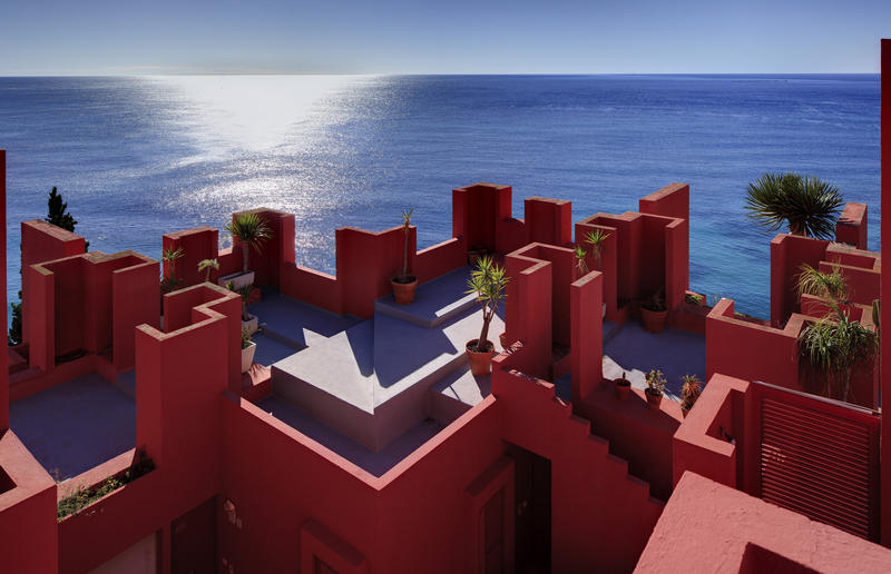 Shades of the World: The Red Walls of La Muralla Roja overlooking a beach