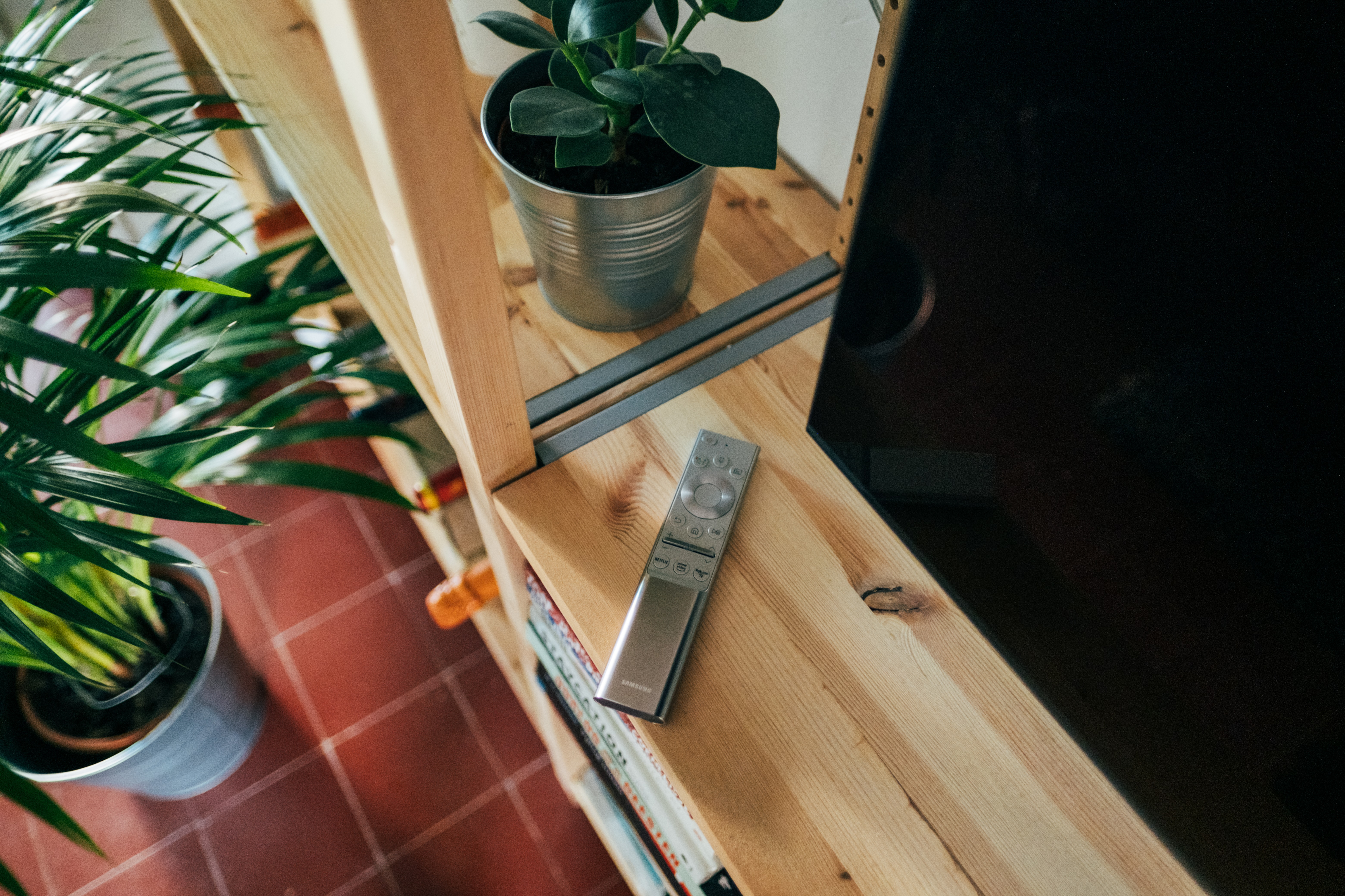 silver remote control on brown wooden table